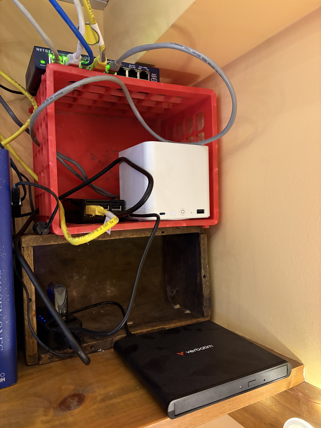 Network switch, Raspberry Pi, Beelink ME min, and CD-ROM drive in crates on a shelf
