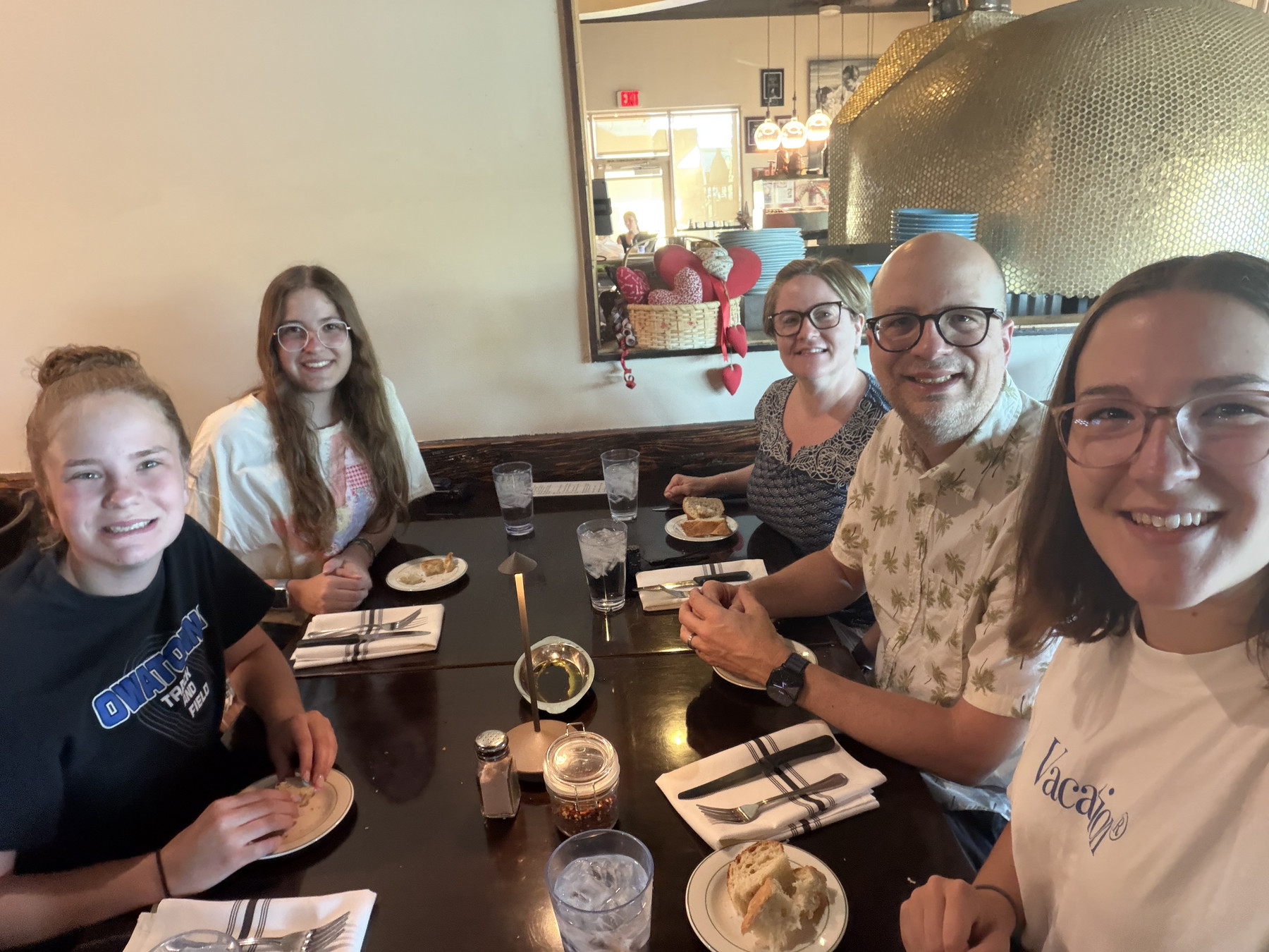 The five of us gathered around the a table at the restaurant.