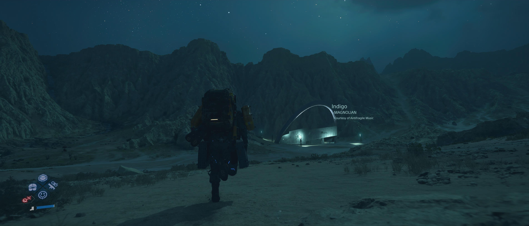 Screenshot from Death Stranding 2. Sam is running towards a distribution center in the mountains while MAGNOLIAN’s Indigo is playing.