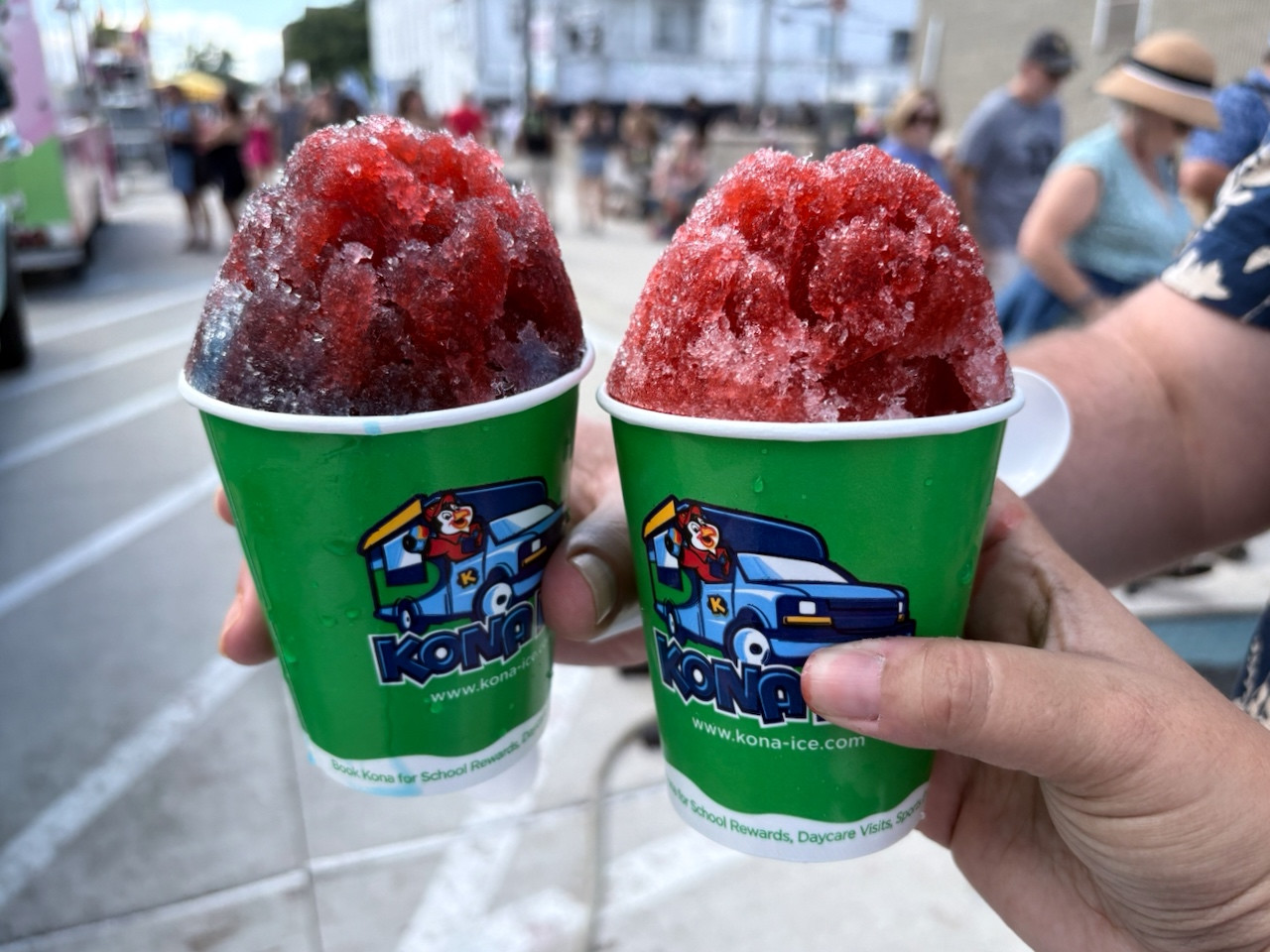 Two shaved ice treats with cherry flavoring