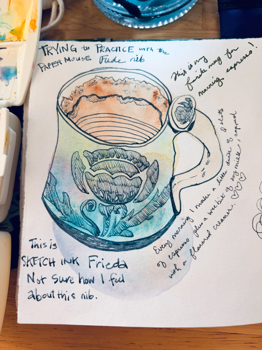 A pen and ink sketch of a small mug of espresso. It has a flower on it, and has a light watercolor wash of blue and green, and rambly notes about ink colors and coffee love winding around.