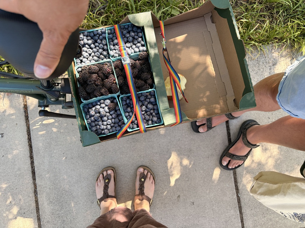 Looking down at the berries on the back of my bike. Mine and Greg’s feet are visible.