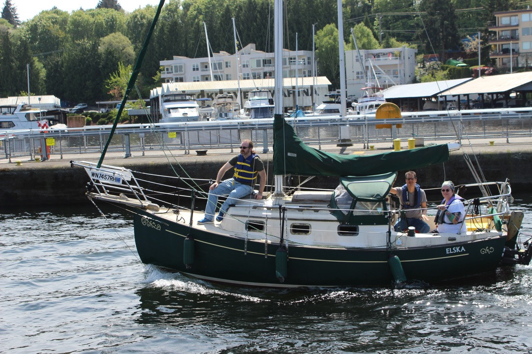 A Flick 20 going through the Ballard Locks in Seattle. There are three people aboard, and none of them are horsing around.