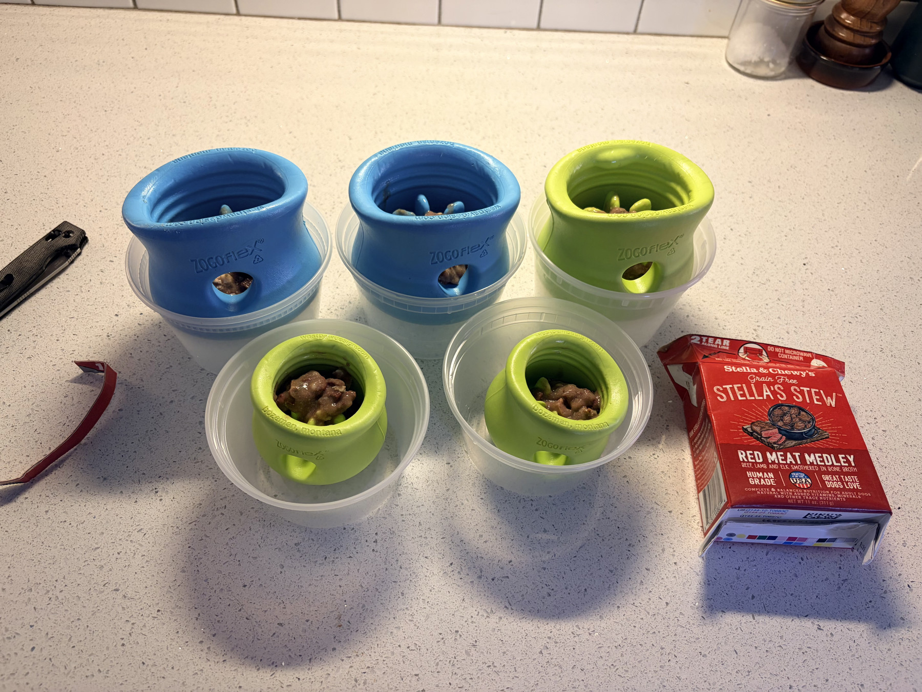 Putting wet dog food in treat containers to be frozen